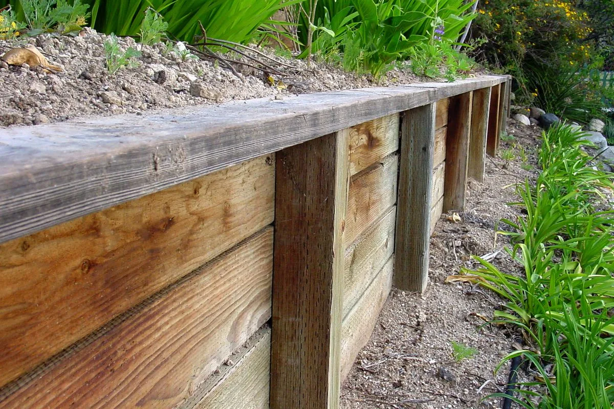 Close-up of a timber sleeper retaining wall with timber posts